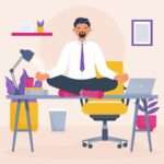 Man meditating cross-legged on office desk in work attire, surrounded by office items and plants.